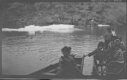 Image of Women, children in boats, icebergs near